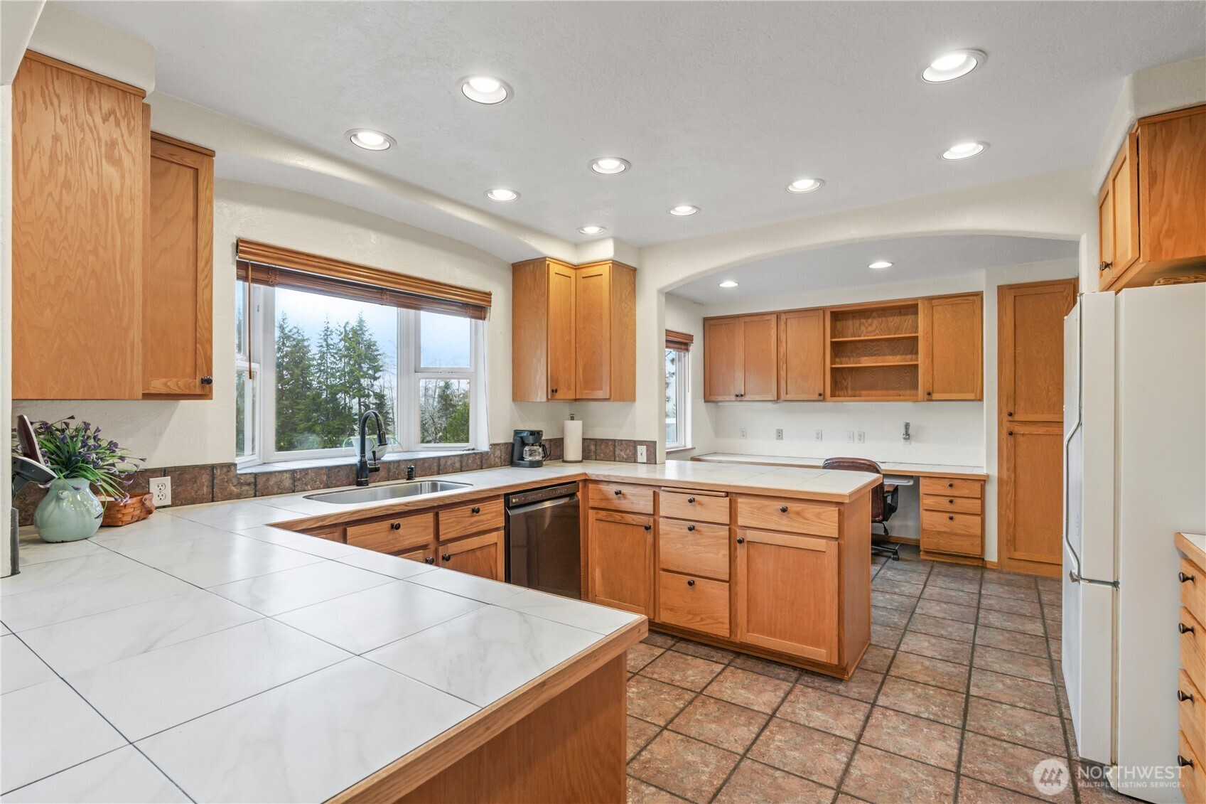 245 Joe Rocky Road Raymond, WA 98577 - Photo 8 of 40 a large kitchen with kitchen island a sink a counter top space and stainless steel appliances