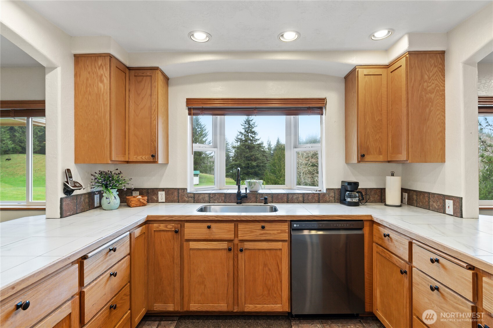 245 Joe Rocky Road Raymond, WA 98577 - Photo 9 of 40 a kitchen with kitchen island granite countertop a sink a counter space appliances and cabinets