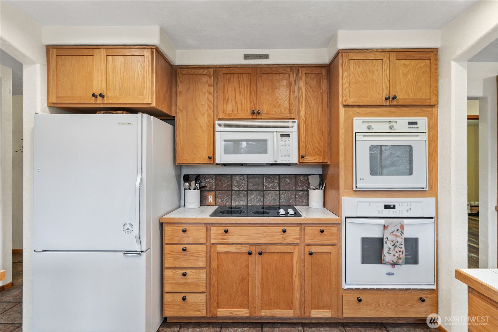 245 Joe Rocky Road Raymond, WA 98577 - Photo 10 of 40 a kitchen with cabinets appliances and a window