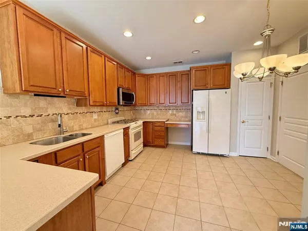 a kitchen with stainless steel appliances a stove a sink a microwave and cabinets