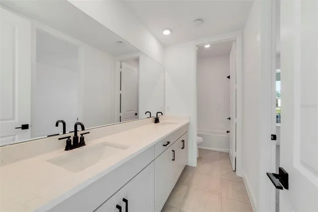 a bathroom with a double vanity sink and mirror