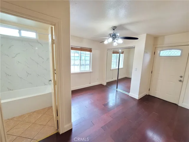 wooden floor in an empty room with a window