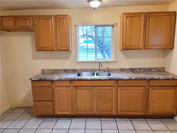 a kitchen with a sink window and cabinets