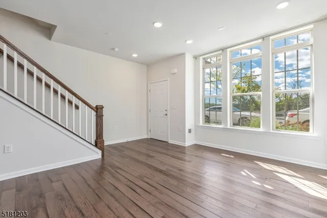 a view of an entryway with wooden floor