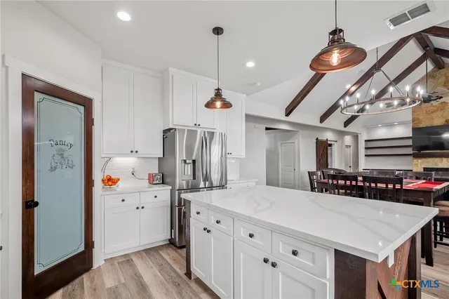 a kitchen with stainless steel appliances a sink stove and refrigerator