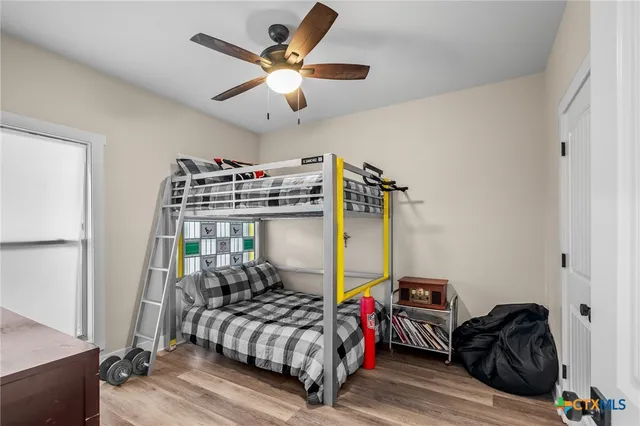 a bedroom with bed and a chandelier