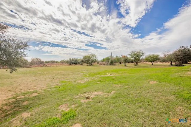 a aerial view of a house with swimming pool garden and lake view