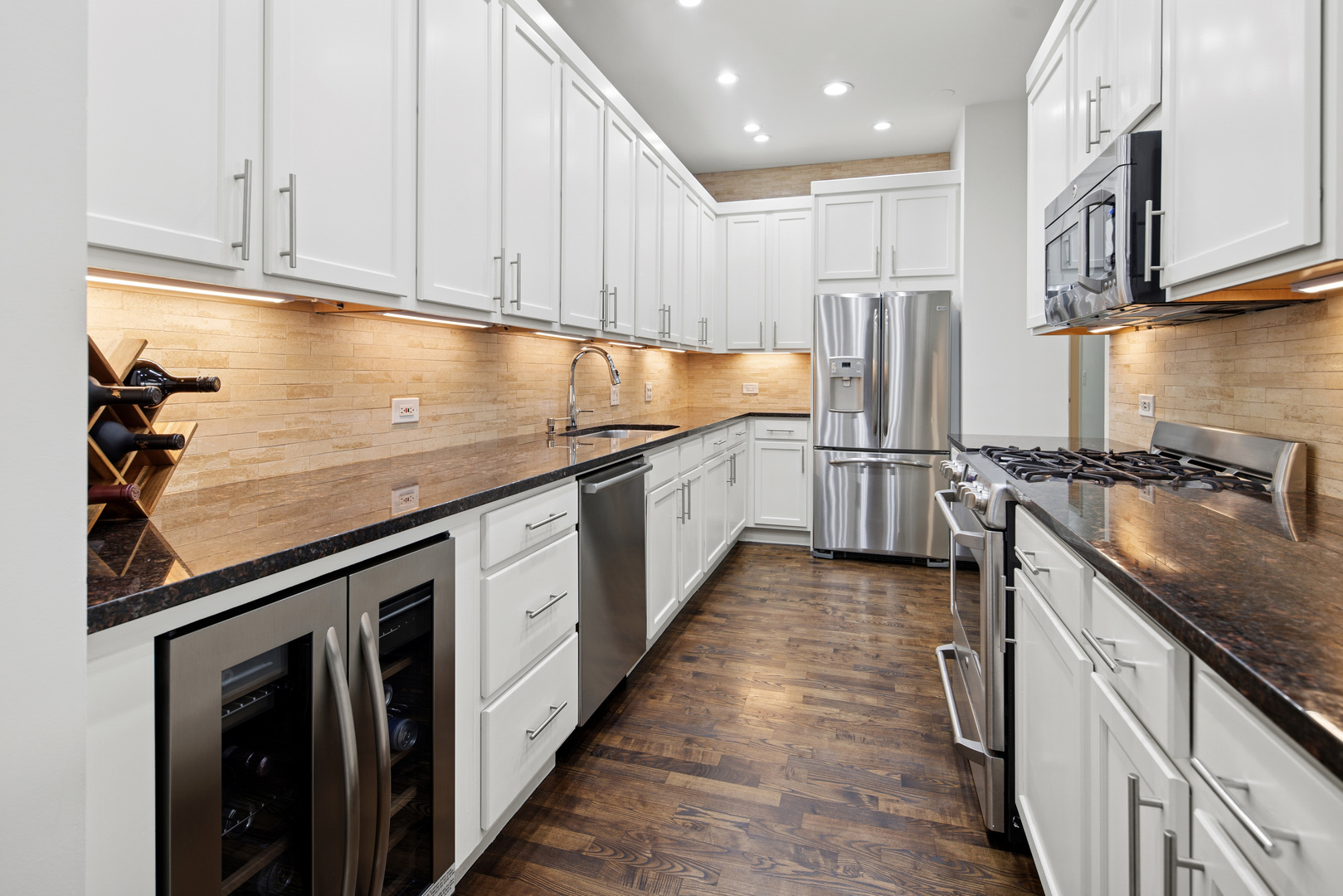560 West Fulton Street, Unit 503 Chicago, IL 60661 - Photo 11 of 25 a kitchen with stainless steel appliances granite countertop a sink a stove and a refrigerator