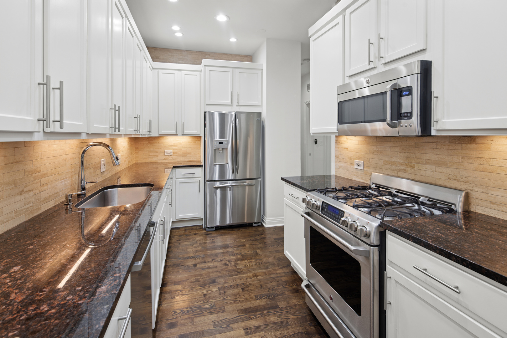 560 West Fulton Street, Unit 503 Chicago, IL 60661 - Photo 13 of 25 a kitchen with wooden cabinets stainless steel appliances and a counter space