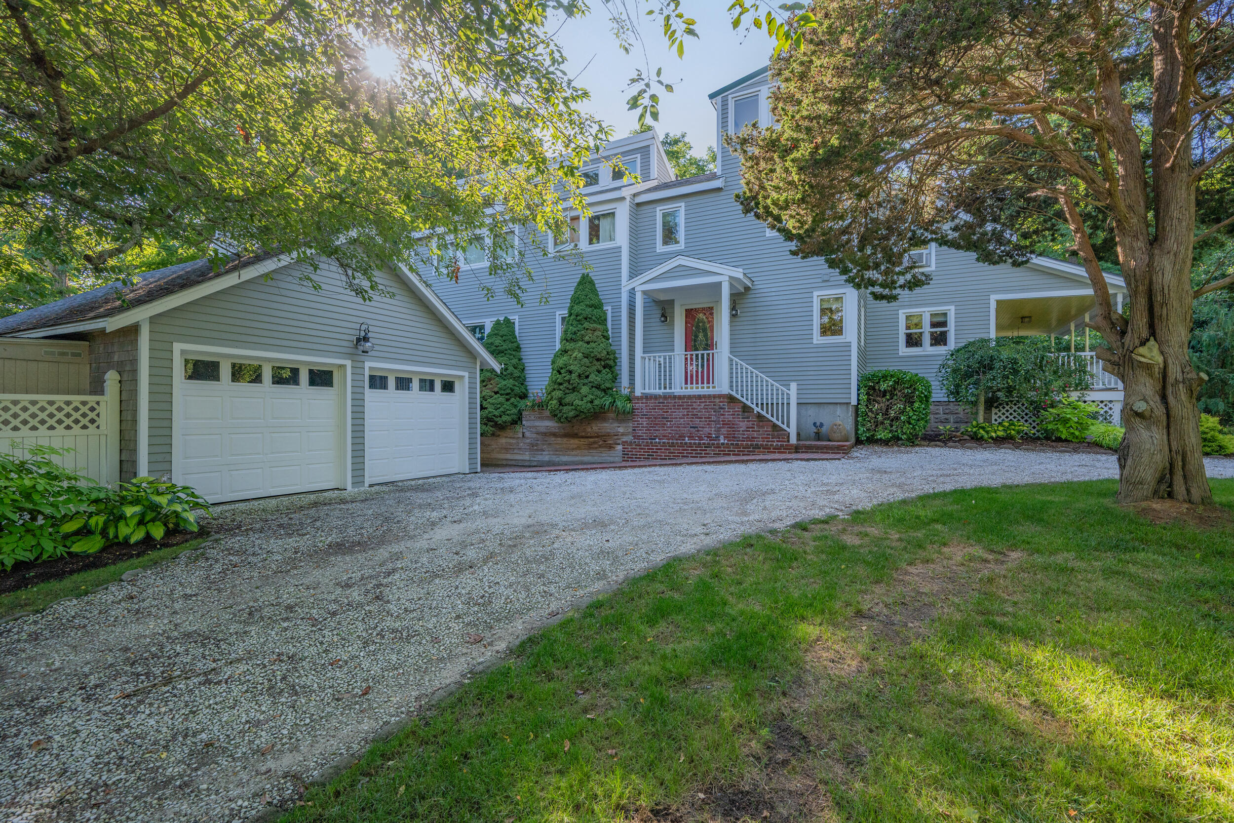 1875 State Highway Eastham, MA 02642 - Photo 42 of 69 a front view of a house with a garden and trees