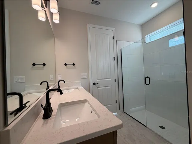 a bathroom with a sink and mirror