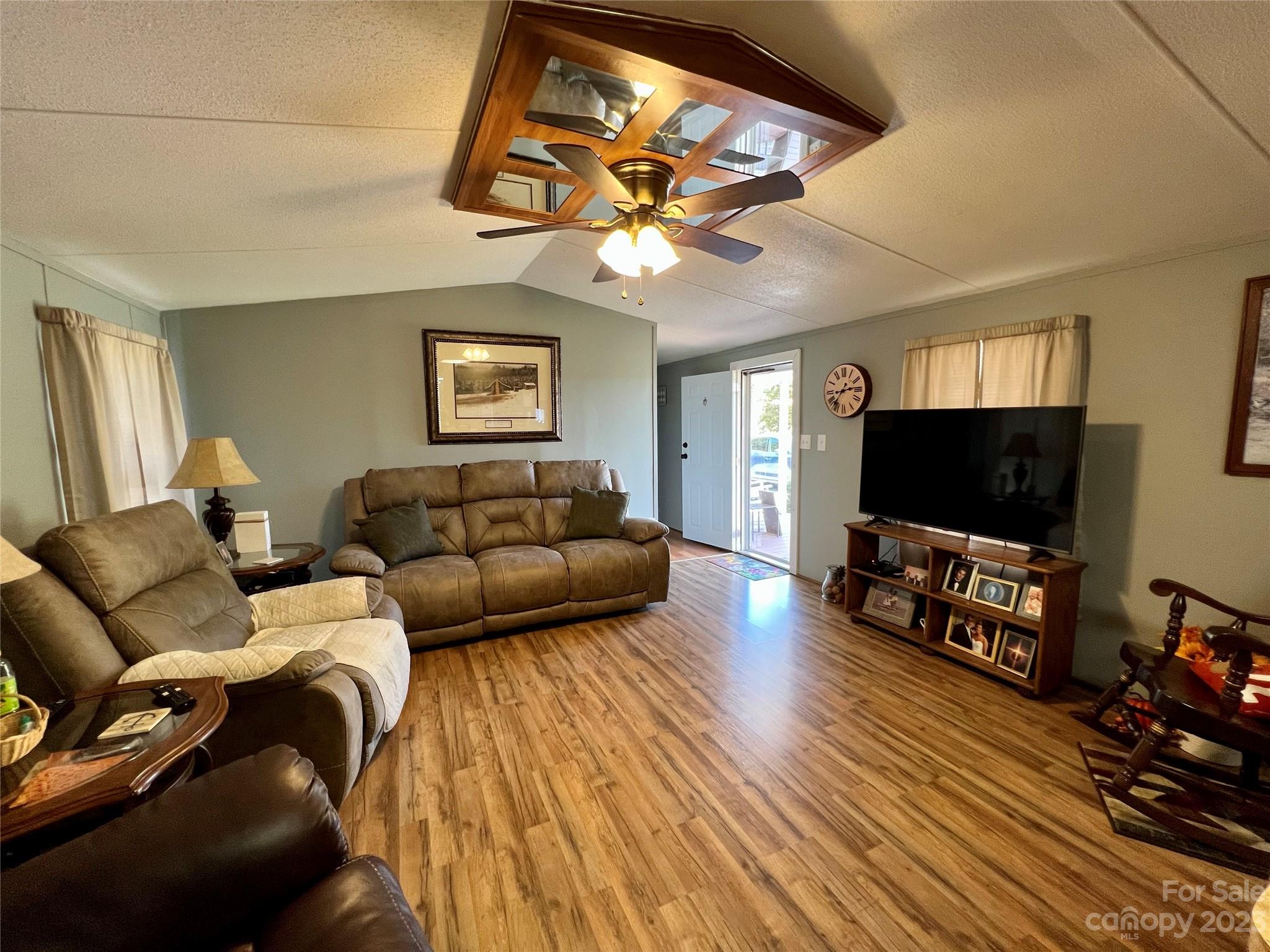 1508 Scenic View Road Hickory Grove, SC 29717 - Photo 13 of 24 a living room with furniture a flat screen tv and a chandelier