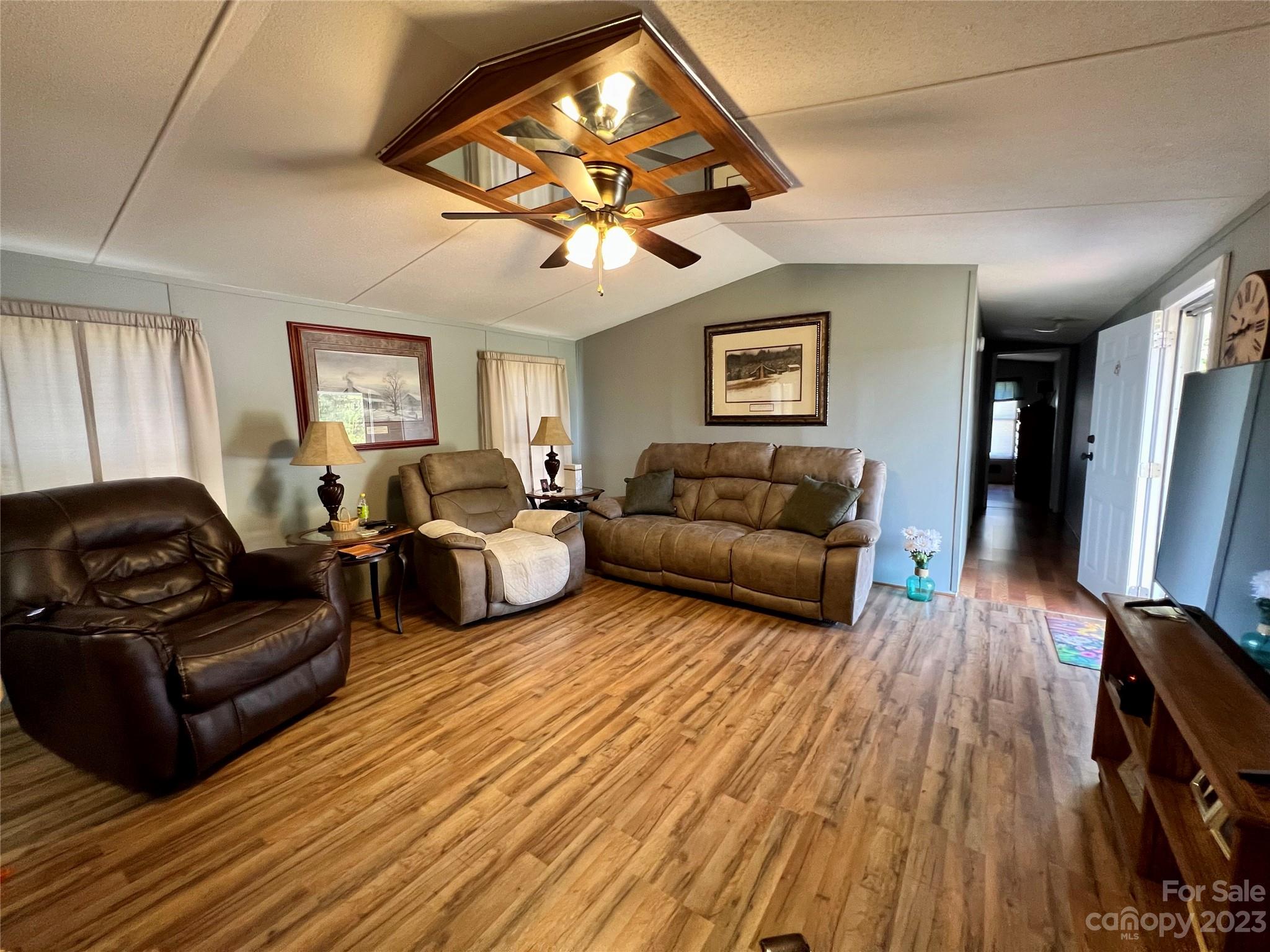 1508 Scenic View Road Hickory Grove, SC 29717 - Photo 14 of 24 a living room with furniture a flat screen tv and a ceiling fan