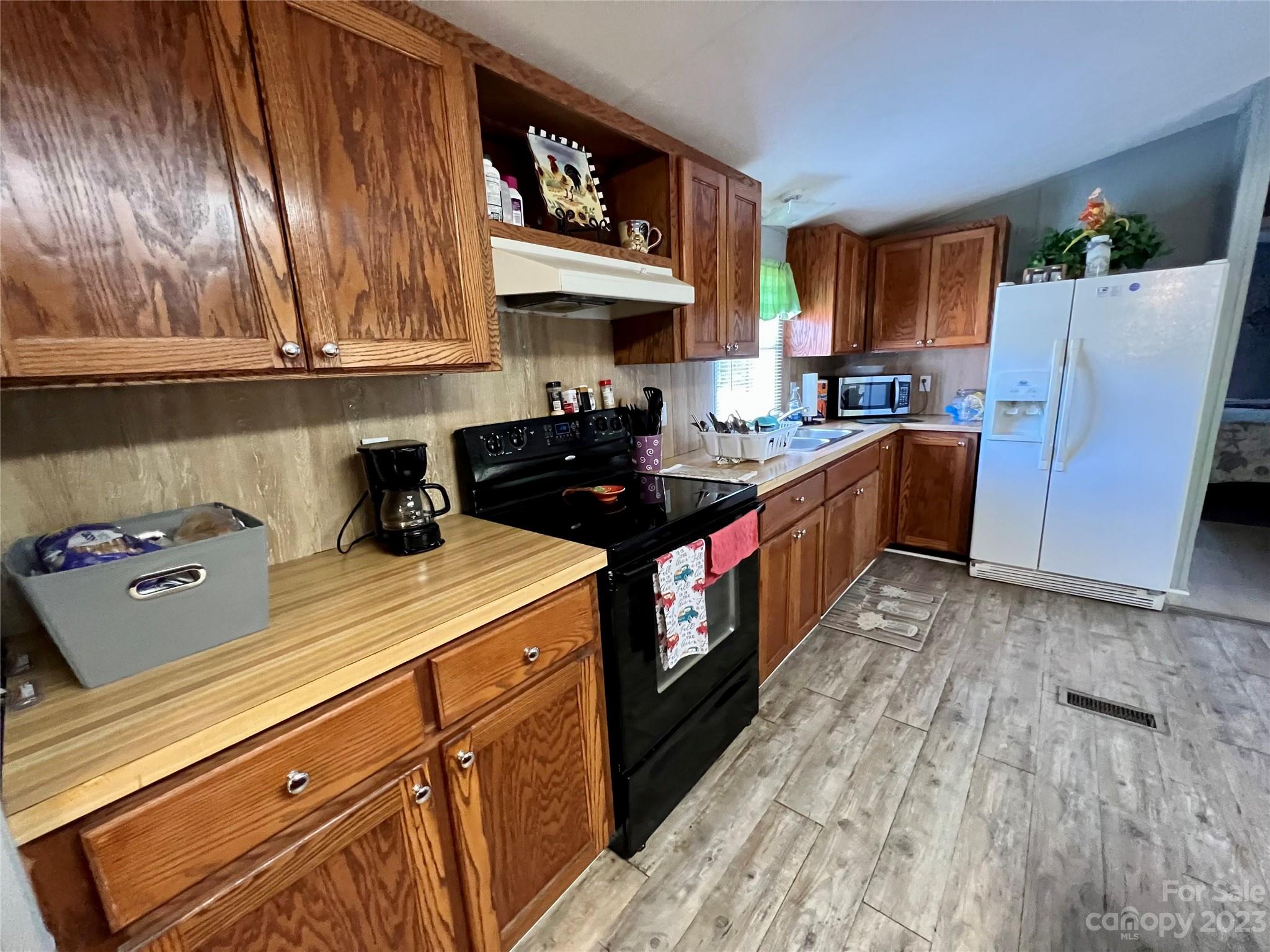 1508 Scenic View Road Hickory Grove, SC 29717 - Photo 5 of 24 a kitchen with granite countertop a sink a stove and refrigerator
