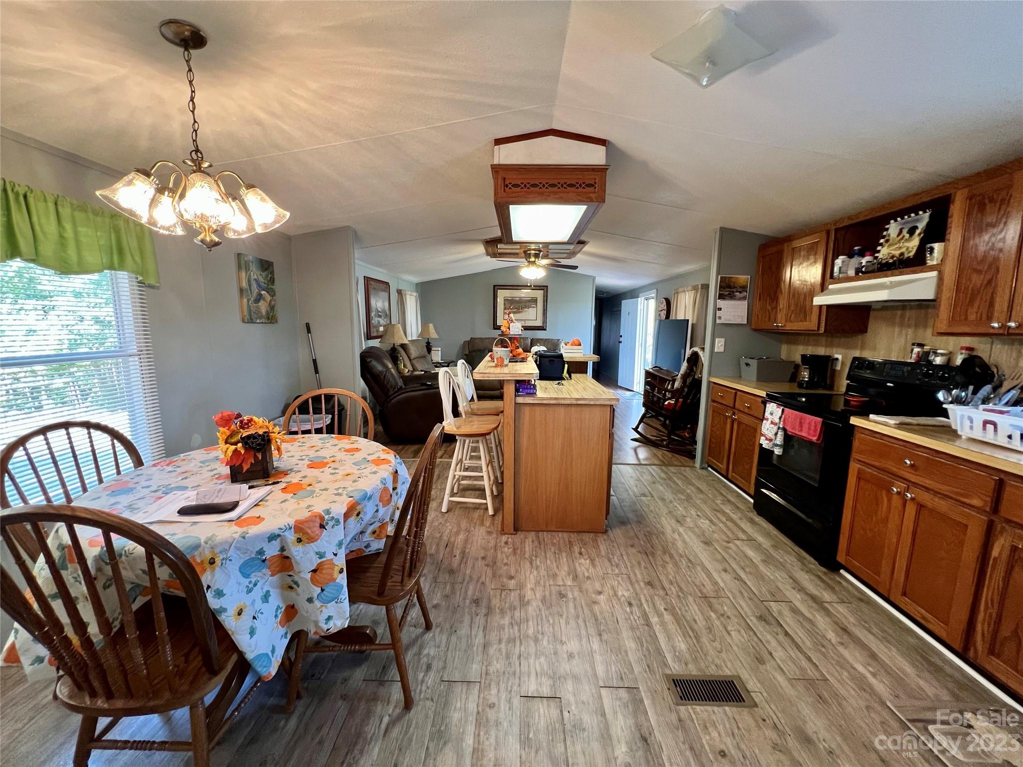 1508 Scenic View Road Hickory Grove, SC 29717 - Photo 6 of 24 a view of a dining room with furniture a chandelier and wooden floor