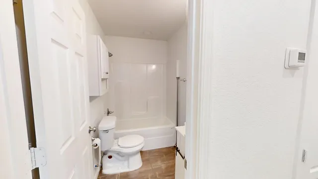 a bathroom with a toilet and a shower