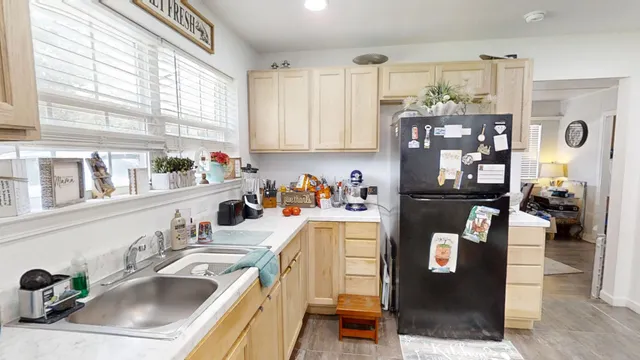 a kitchen with a sink a stove and cabinets