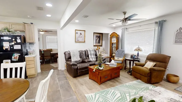 a living room with furniture and wooden floor