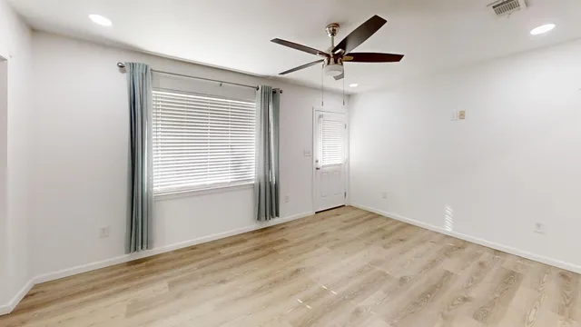wooden floor in an empty room with a window