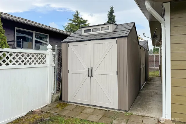 a view of a yard with plants and trees