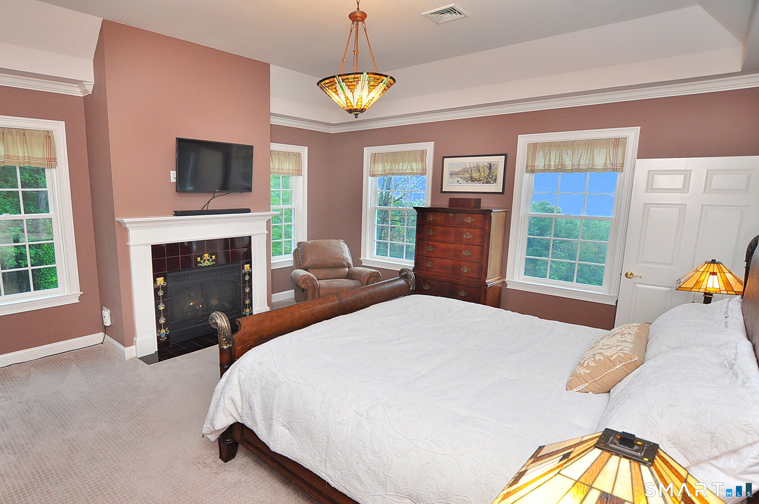 15 Old Orchard Road Granby, CT 06090 - Photo 29 of 40 The fireplace in the primary bedroom features a fireplace with imported tubeline tiles.