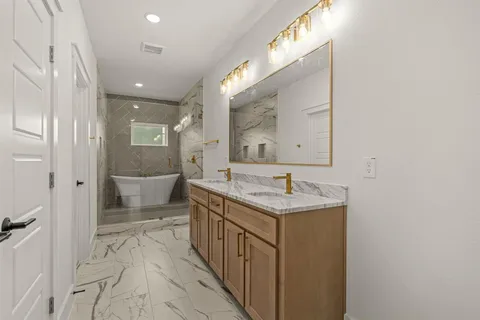 a bathroom with a granite countertop sink a mirror and a toilet