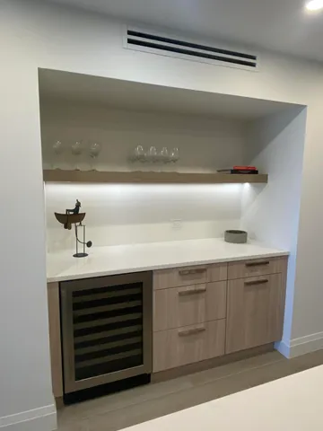 a bathroom with a sink a toilet a mirror and a glass door shower