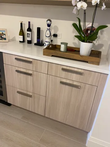 a kitchen with a potted plant on the counter and cabinets