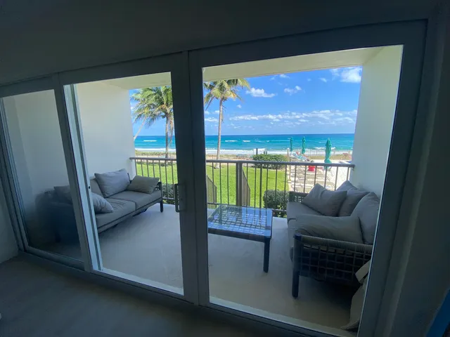 a living room with furniture and a floor to ceiling window