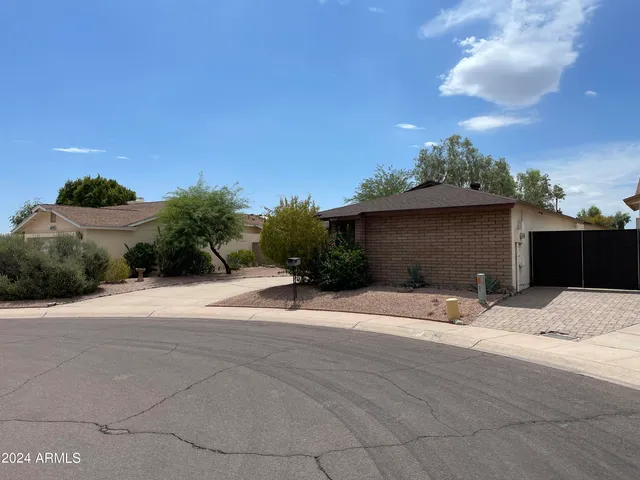 a backyard of a house with plants and trees