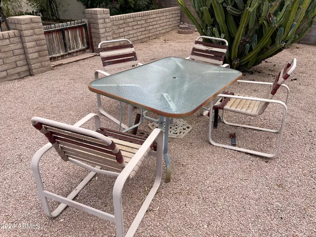 a view of a backyard with sitting area