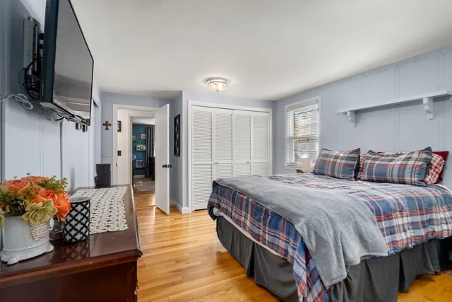 a bedroom with bed and a flat screen tv