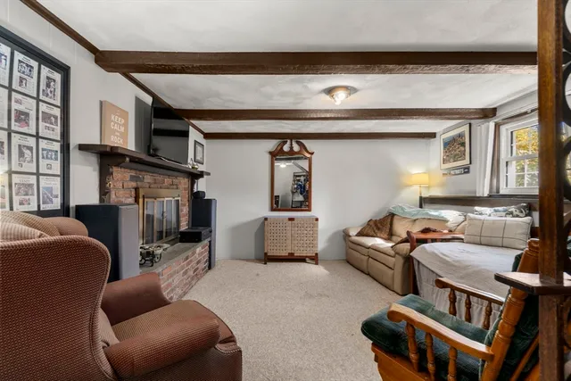 a living room with furniture a flat screen tv and a couch