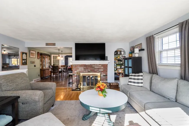 a living room with fireplace furniture and a flat screen tv