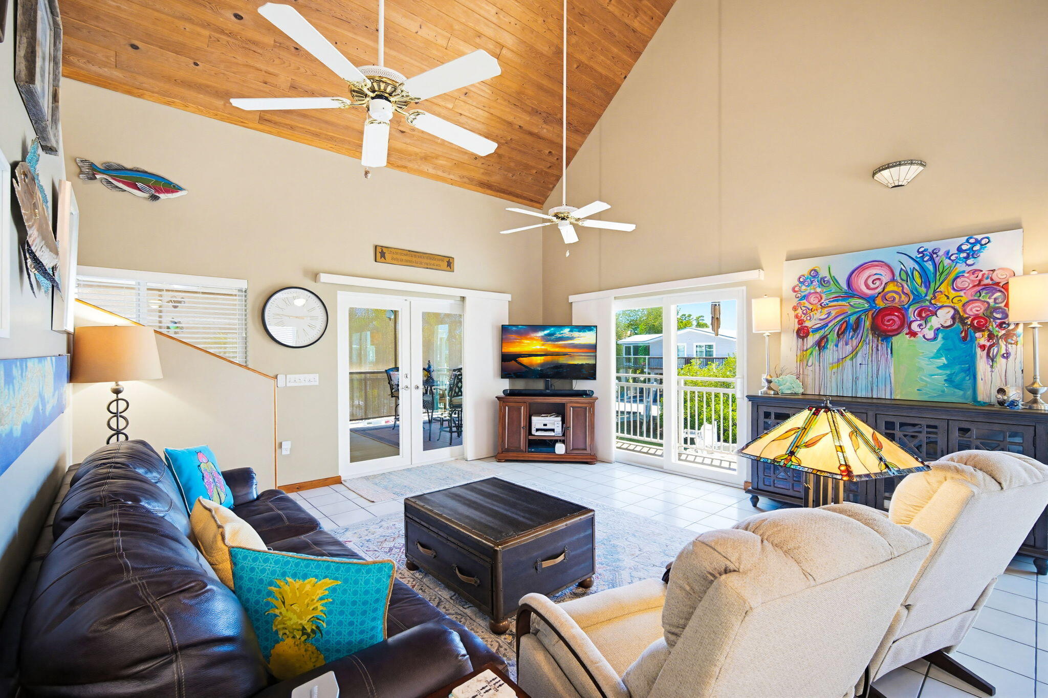612 Blackbeard Road Summerland Key, FL 33042 - Photo 17 of 68 a living room with furniture a flat screen tv and a floor to ceiling window