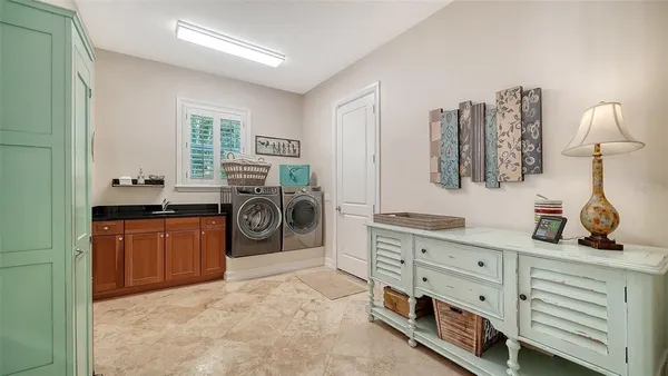 a view of a bedroom with furniture and a window