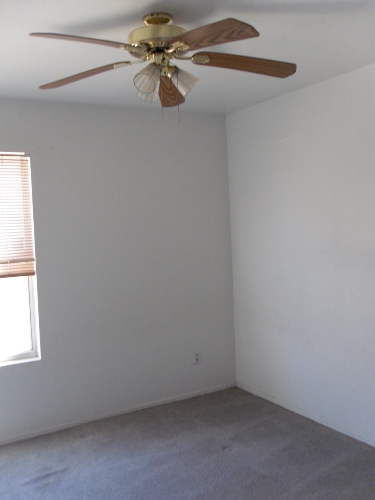 1431 East Carson Road Phoenix, AZ 85042 - Photo 16 of 25 an empty room with a window and a fan