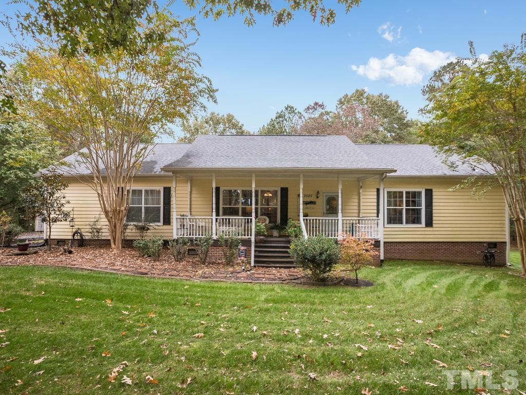 a front view of house with yard and outdoor seating
