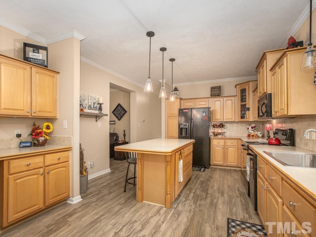 2525 Baptist Road Durham, NC 27703 - Photo 11 of 23 a kitchen with a sink stove and refrigerator