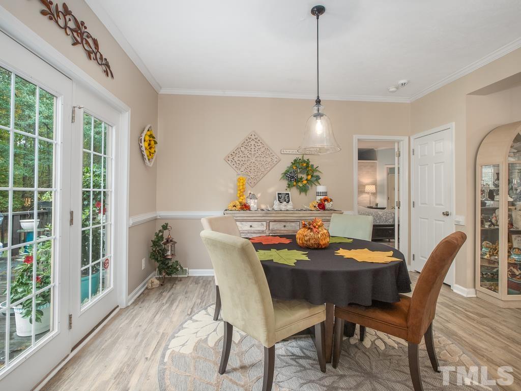 2525 Baptist Road Durham, NC 27703 - Photo 13 of 23 a dining room with furniture a chandelier and wooden floor