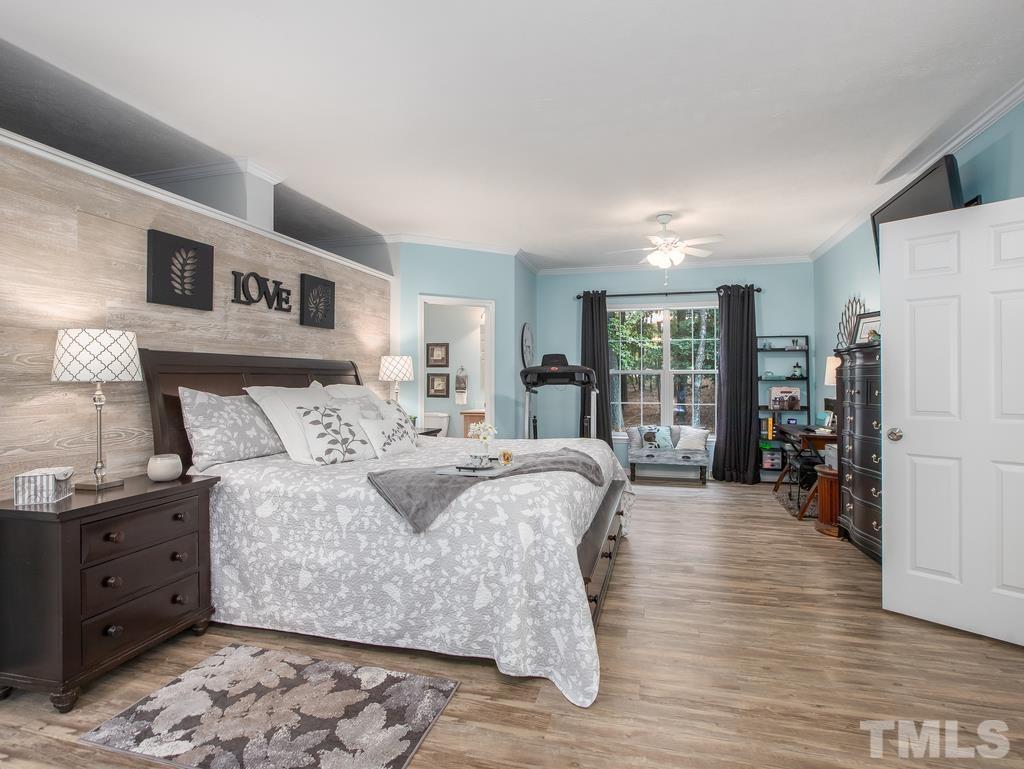 2525 Baptist Road Durham, NC 27703 - Photo 14 of 23 a large bedroom with a bed and wooden floor