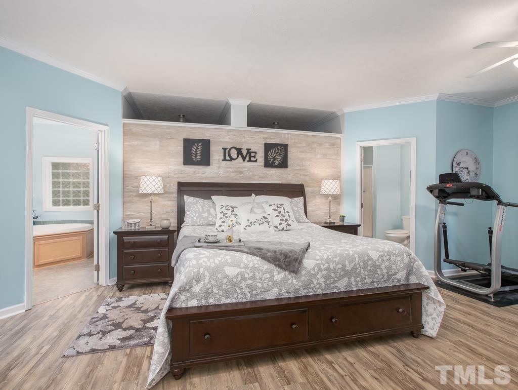 2525 Baptist Road Durham, NC 27703 - Photo 15 of 23 a bedroom with a bed and wooden floor
