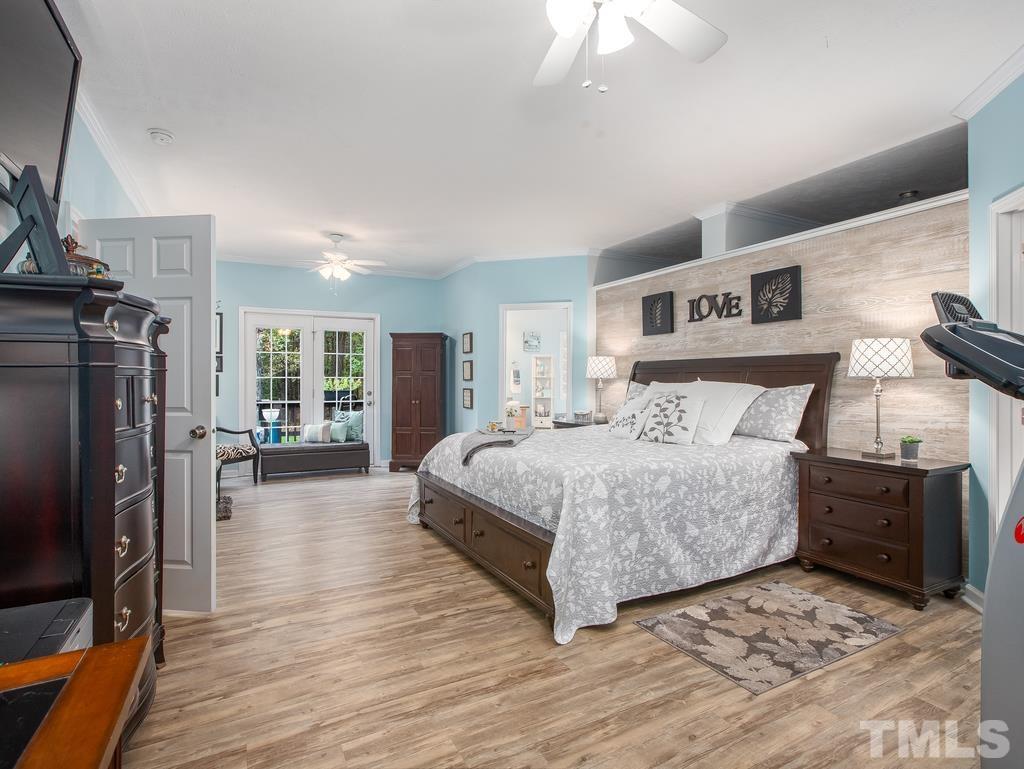 2525 Baptist Road Durham, NC 27703 - Photo 16 of 23 a bedroom with a bed and wooden floor