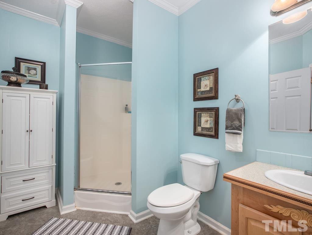 2525 Baptist Road Durham, NC 27703 - Photo 17 of 23 a bathroom with a toilet a sink and mirror