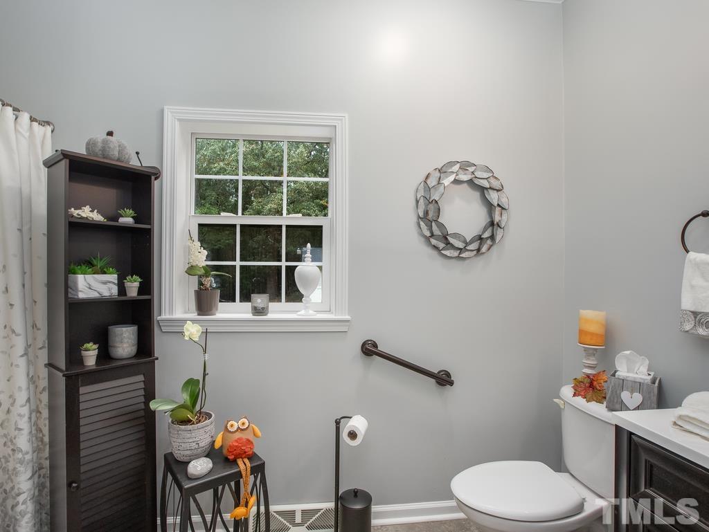 2525 Baptist Road Durham, NC 27703 - Photo 6 of 23 a bathroom with a toilet a sink and a window