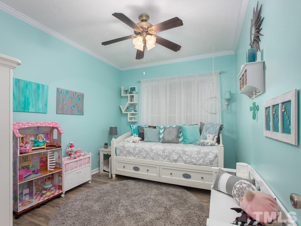 2525 Baptist Road Durham, NC 27703 - Photo 9 of 23 a bedroom with a bed and a chandelier