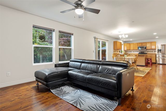 a view of a dining room with furniture wooden floor and chandelier