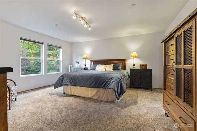 a bedroom with a large bed and a chandelier