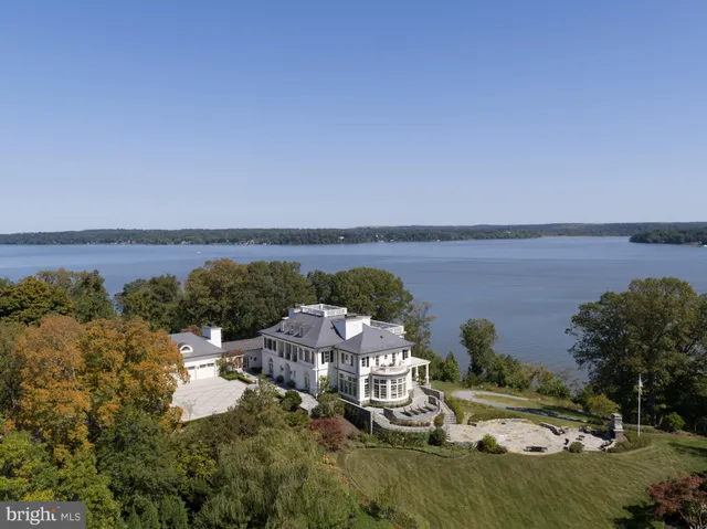 an aerial view of a house with a lake view