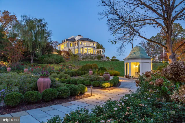 a front view of a house with yard and green space